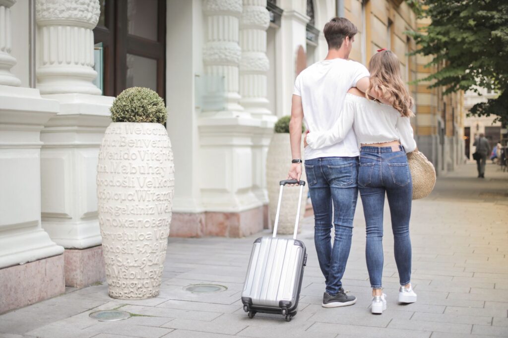 Traveller wheeling a cabin-size carry-on suitcase that meets the 22 by 14 by 9 inch airline size limit