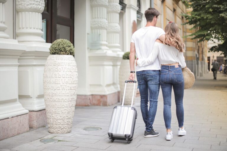 Traveller wheeling a cabin-size carry-on suitcase that meets the 22 by 14 by 9 inch airline size limit