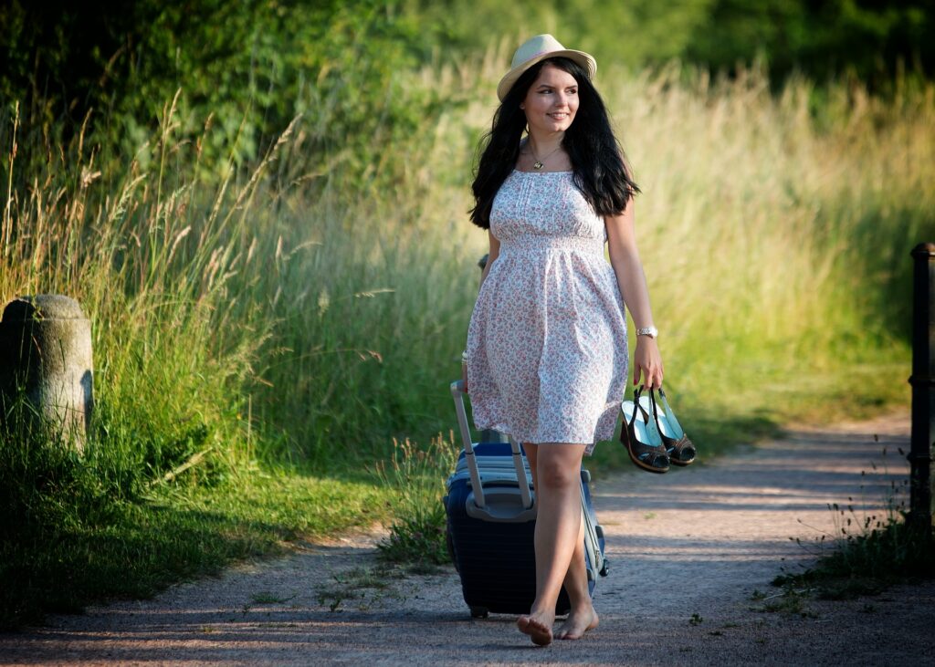 Traveler pulling a rolling suitcase along a path, packed within Alaska Airlines checked bag limits