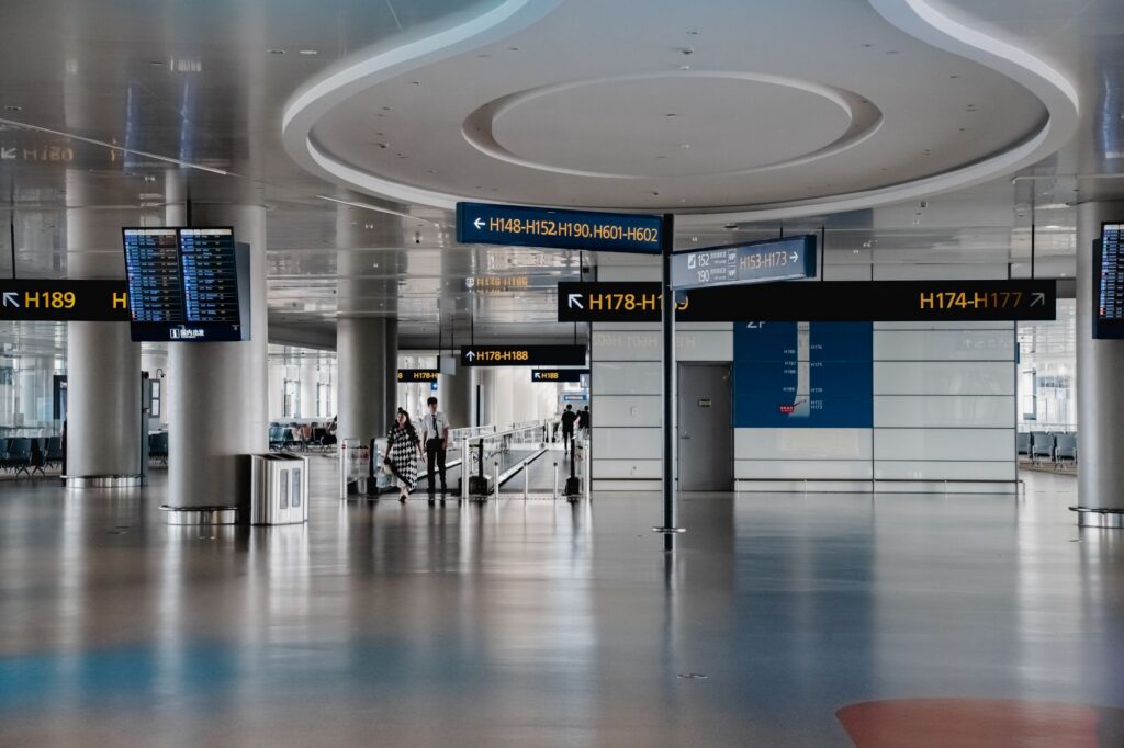 Modern airport terminal interior showing gate directional signage