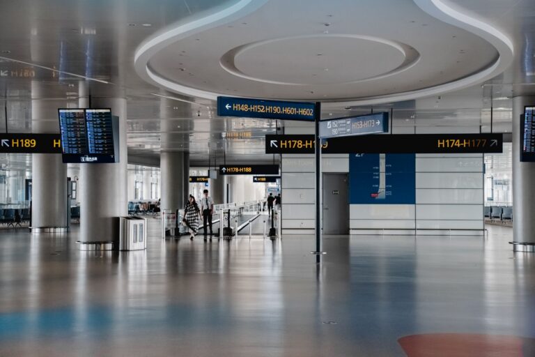 Modern airport terminal interior showing gate directional signage