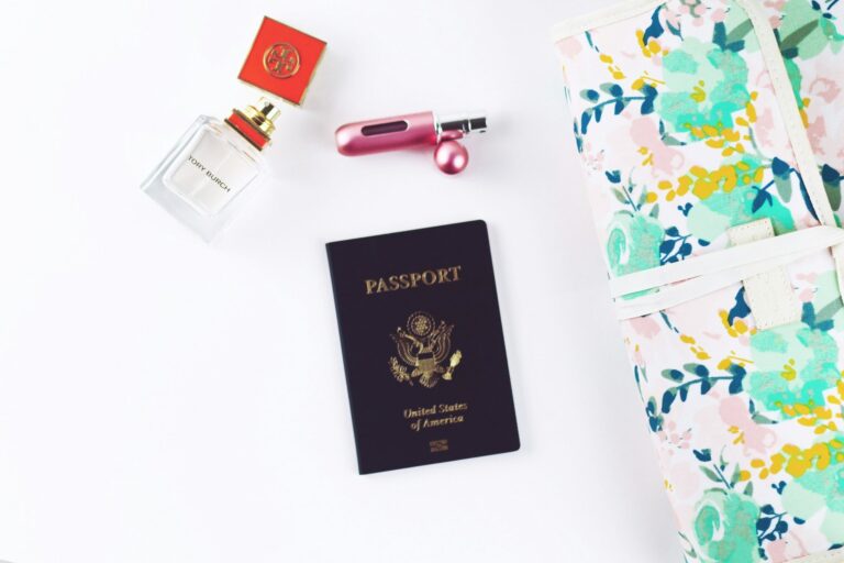 US passport and travel toiletries laid out before packing a checked bag