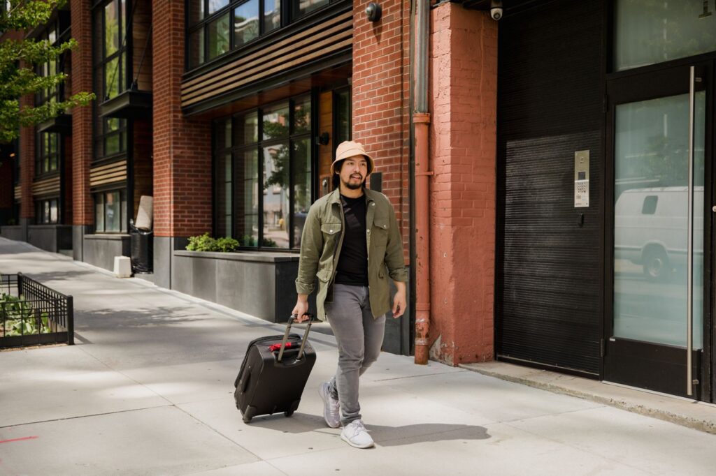Traveler walking with a suitcase, relevant to REAL ID and Global Entry card rules for TSA