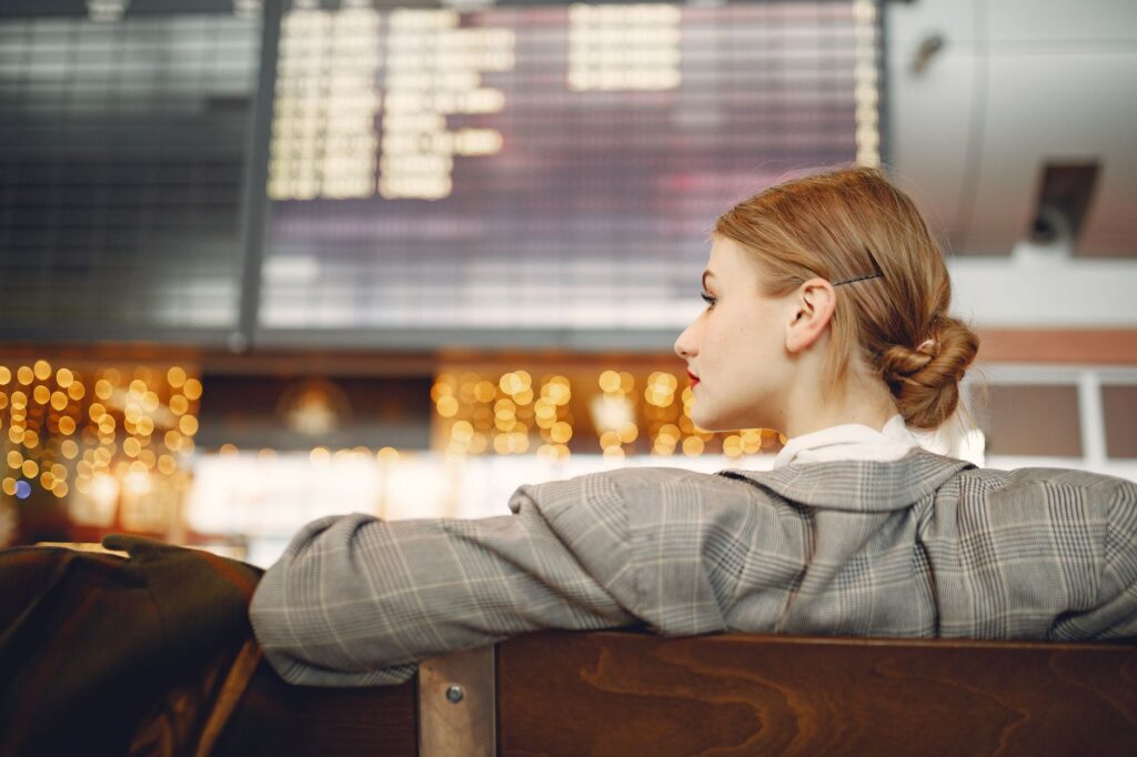 Traveler checking an airport departure board during a layover