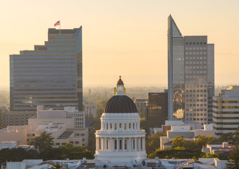 Aerial view of the California State Capitol dome in Sacramento at sunset