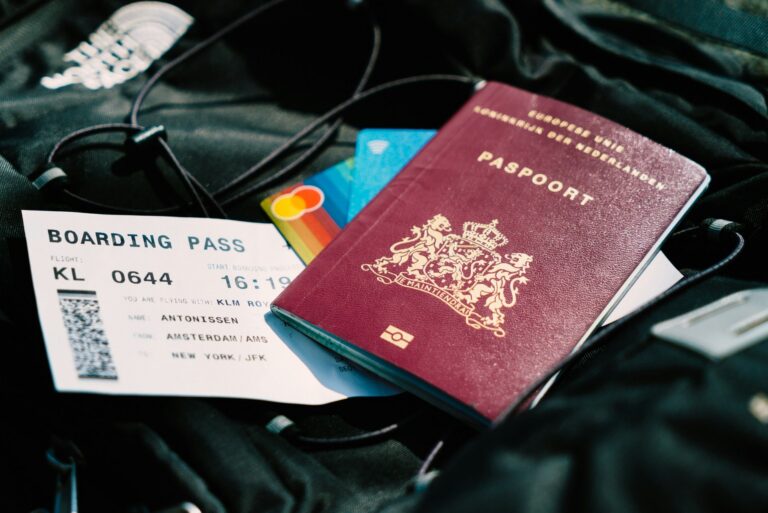 A passport and boarding pass resting on a bag, representing travel document requirements