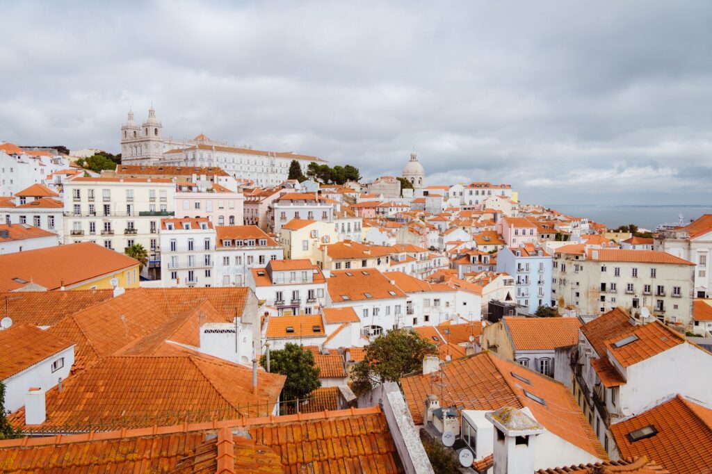 Red rooftops of Alfama in Lisbon with São Vicente de Fora on the skyline, the old town you see on day one