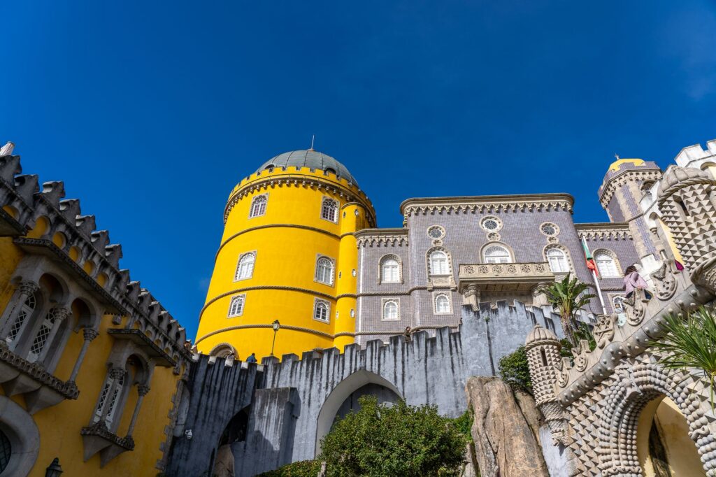 The yellow and grey towers of the Pena Palace in Sintra, day three of a three-day Lisbon itinerary