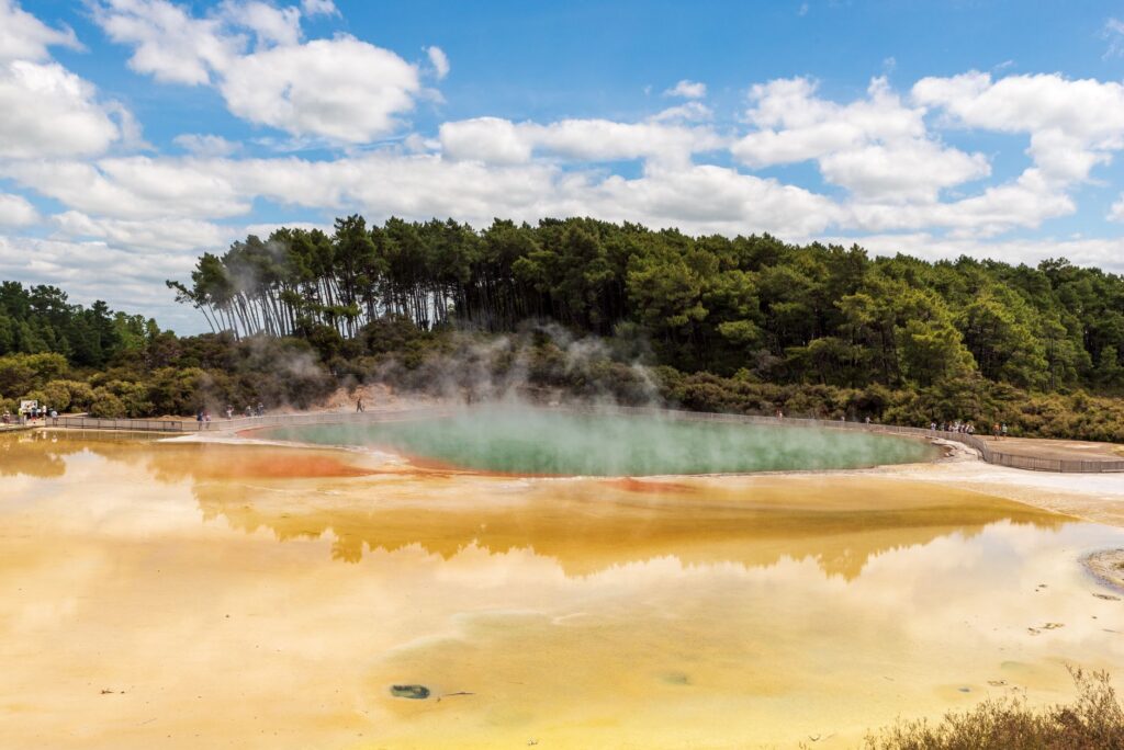 Steam rising from the Champagne Pool at Wai-O-Tapu, south of Rotorua, on a New Zealand itinerary for 7 days